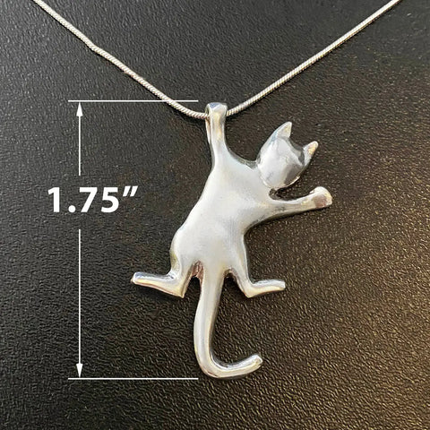 The Solid Sterling Silver Cat Necklace Style #1 by Skinny Petes Gourmet Catnip features a pendant with outstretched legs on a chain, shown against a black background. A white line shows its 1.75 tall—handcrafted cat lover jewelry made in the USA.