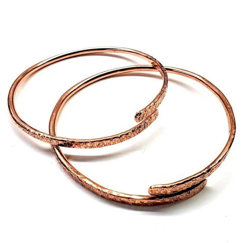 The Adjustable 10 Gauge Copper Hammer Textured Overlap Bangle by Alexa Martha Designs features a handmade, textured pattern—an elegant copper anniversary gift option.