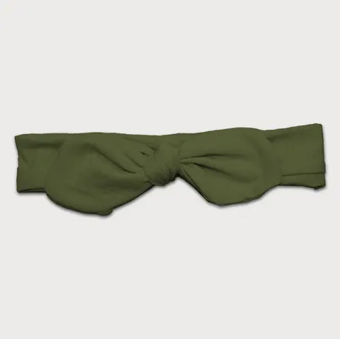 The Goodnighties Knotted Bow Headband in olive green features a large front bow and an adjustable design for comfort and style, shown laid flat on a white background.