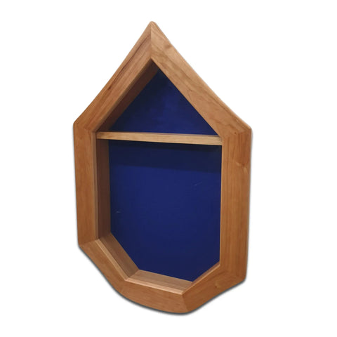 The Legacies of America Woodworking Company Air Force SNCO Military Retirement Shadow Box - Cherry is USA-made from cherry hardwood, with a pentagon-shaped frame, pointed top, single shelf, blue fabric background, and shown empty on white.