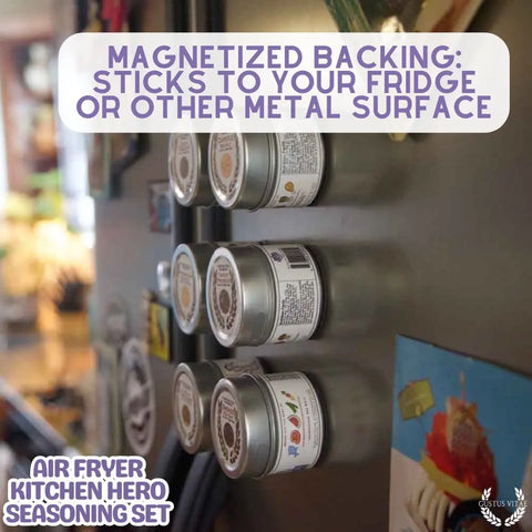 Six artisanal spice tins from the Gustus Vitae Air Fryer Gourmet Seasoning Set are magnetically attached to a refrigerator door, featuring labeled lids and a magnetized backing. Text highlights the USA-made gourmet blends designed for air fryer cooking.