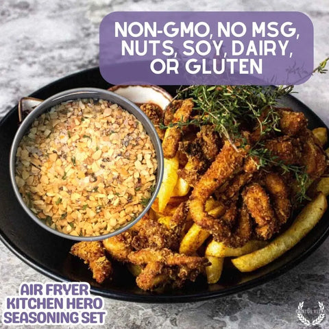 A bowl of Gustus Vitae's Air Fryer Gourmet Seasoning Set – Six Artisanal Spice Blends sits by fries, garnished with herbs. Made in USA, non-GMO, and free from MSG, nuts, soy, dairy & gluten.
