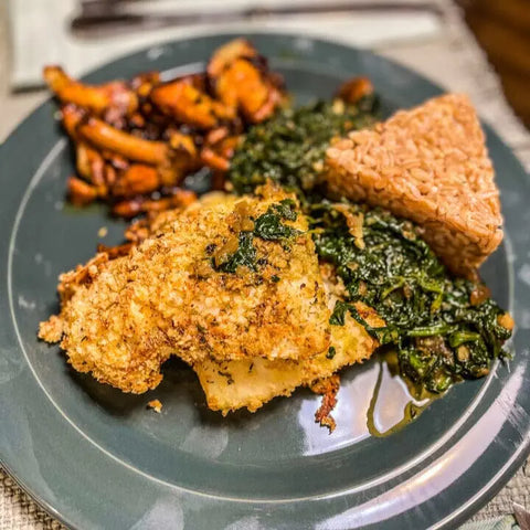Enjoy a plate of breaded, baked fish, sautéed greens, brown rice, and roasted carrots—all seasoned with Gustus Vitae’s Air Fryer Kitchen Hero Seasoning Set artisanal spice blends and crafted using non-GMO ingredients.