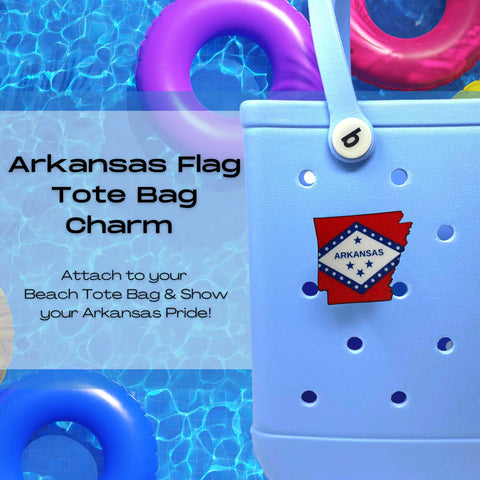 A Chatelet Manufacturing Boglets USA Flag Charm decorates a tote bag near a pool with colorful inflatables. Text: “Boglets—USA Flag Charms for Bogg Bags. Show your patriotic pride at the beach!”.