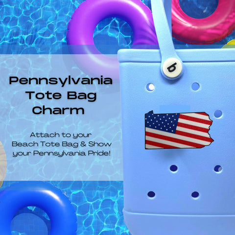 A blue tote bag by the pool with a USA flag Pennsylvania charm. Text: Boglets - USA Flag Charms for Bogg Bags & more by Chatelet Manufacturing. Show off your Pennsylvania pride! Compatible with various tote brands.