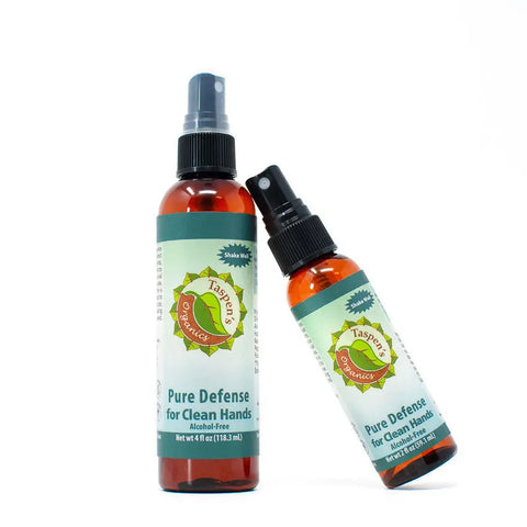 Two PURE Defense for Clean Hands: NO-Alcohol spray bottles by Taspens Organics are displayed on a white background—one upright, the other leaning—featuring their alcohol-free hand spray formula.