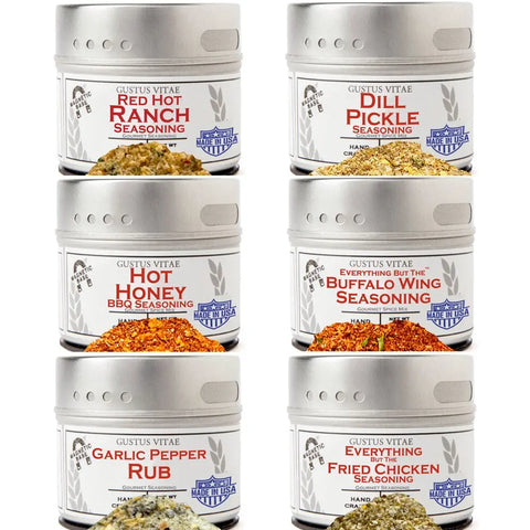 The Gustus Vitae All American Wings Seasoning Set features six silver tins in two columns with flavors like Red Hot Ranch, Dill Pickle, Hot Honey BBQ, Buffalo Wing, Garlic Pepper Rub, and Everything Fried Chicken—perfect for gourmet cooking.