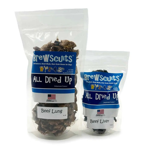 Two clear Brewscuits All Dried Up bags, one with beef lung treats and the other with beef liver, both featuring blue labels that show the dehydrated dog snacks inside.