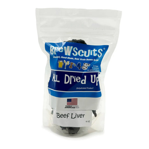A clear bag labeled Brewscuits All Dried Up contains all-natural dehydrated beef liver dog treats. The packaging has a blue and white label, a small American flag, and handwritten Beef Liver.
