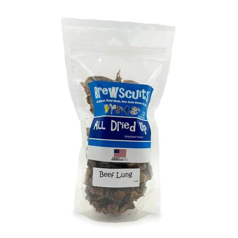 Brewscuits All Dried Up all-natural beef lung dog treats come in a 6 oz resealable blue and white bag with a small American flag and visible dehydrated snacks through the clear packaging.