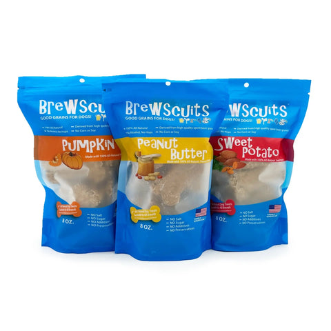 Three blue Brewscuits Original bags are shown side by side, in Pumpkin, Peanut Butter, and Sweet Potato flavors, made with upcycled grains. Each bag displays flavor images and detailed white text, highlighting the eco-conscious dog treats.