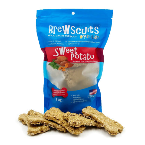 A blue Brewscuits Original bag of eco-friendly dog treats stands upright with tan, rectangular treats in front. The packaging highlights upcycled grains, natural ingredients, and contains no artificial additives.
