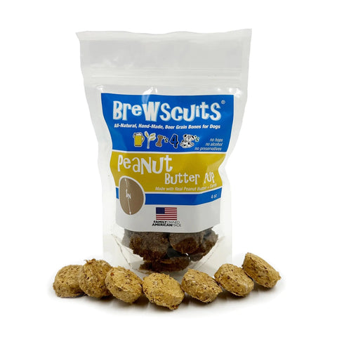 A package of Brewscuits Peanut Butter Pup dog treats is shown in a clear resealable bag with yellow and blue labeling, accompanied by several round, brown treats displayed in front.