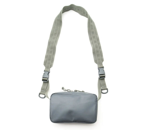 The MIS All Weather Shoulder Bag - Foliage is a small, gray, vinyl-coated polyester crossbody with a rectangular shape, zipper closure, and two wide adjustable straps with plastic buckles, shown on a white background.