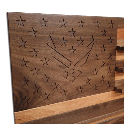 The American Flag Challenge Coin Display - Walnut & Cherry by Legacies of America Woodworking Company features engraved stars and the USAF symbol on alternating walnut and cherry wood stripes, creating a stunning, American-made coin display.