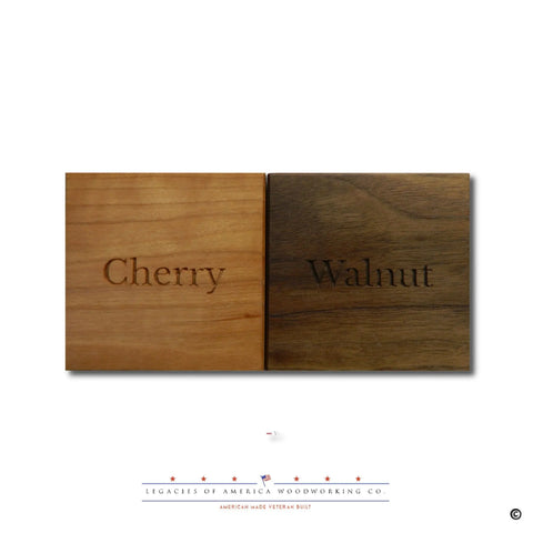 Two wood samples are shown for the American Flag Challenge Coin Display by Legacies of America Woodworking Company: Cherry on the left with a warm red tone, Walnut on the right with a dark brown hue. Company logo is displayed below.