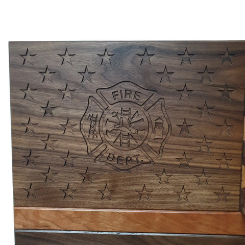The American Flag With Firefighter Cross Challenge Coin Display by Legacies of America Woodworking Company is crafted from walnut and cherry, featuring a FIRE DEPT. emblem, flag-inspired stars, and proudly American Made-Veteran Built™.