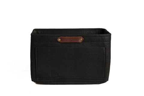 The Urban Southern Tote Insert is a black rectangular fabric bin with a front pocket and small brown leather label, designed for customizable organization as a lightweight felt insert, shown on a white background.