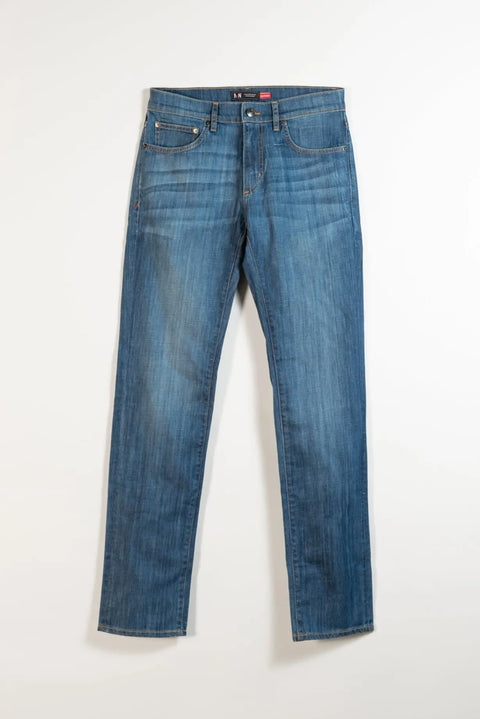 The Nelson Medium Wash Denim by Marc Nelson: classic blue straight slim jeans with five pockets and button closure, shown laid flat on a white background.