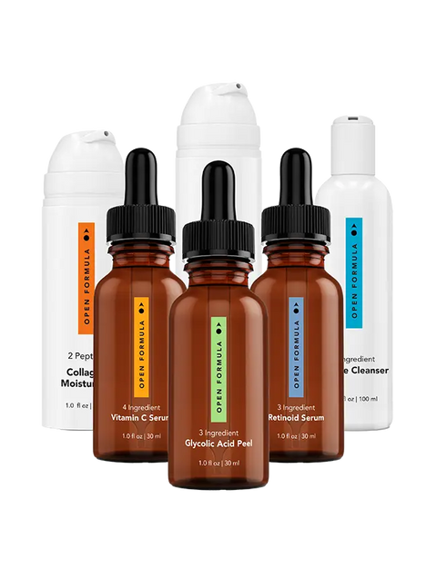 Six Open Formula Transformational Routine skincare bottles are arranged in two rows: three brown dropper bottles with colored labels, including a vitamin C serum, in front and three white pump or squeeze bottles with minimalist labels behind.