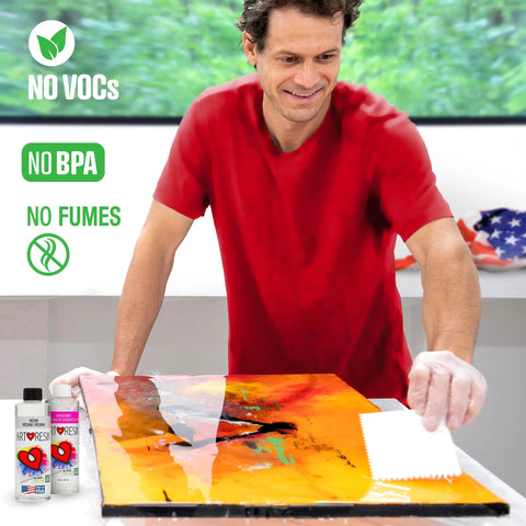 A man in a red shirt applies ArtResin 16 Oz Epoxy Resin to orange and black artwork. Text reads “NO VOCs,” “NO BPA,” and “NO FUMES.” ArtResin bottles and an American flag are visible in the background.
