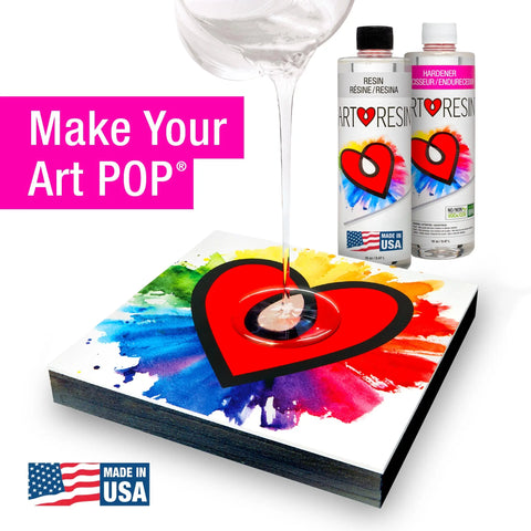 A crystal-clear 32 oz ArtResin epoxy is poured over colorful art with a red heart as two non-toxic ArtResin bottles stand behind. Pink text says Make Your Art POP®. A Made in USA label appears in the corner.