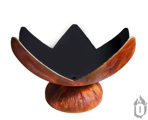 The Ohio Flame Fire Flower Fire Bowl, made in the USA, features a wide, petal-like rust finish on a round base and black interior, accented by a small flame icon in the bottom right corner.