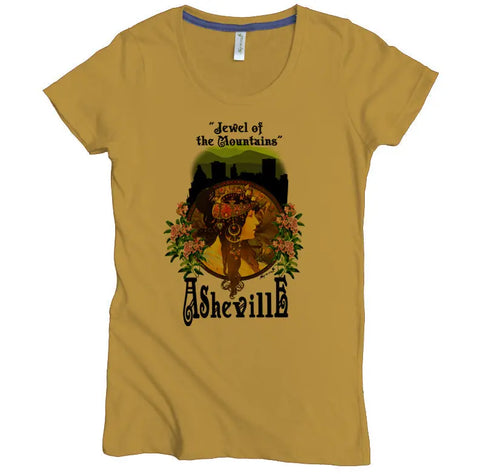 The Jewel of the Mountains Graphic Tee by Spiritex | Sustainable Apparel is a mustard yellow women’s fitted tee with an art nouveau woman, floral design, Asheville lettering, and mountain skyline. Made from 100% organic cotton.