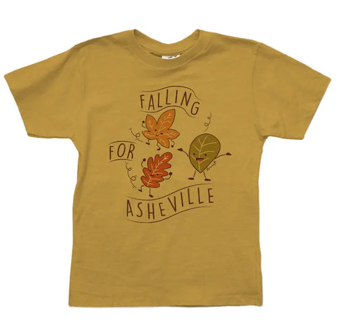 The Asheville Fall Leaves Graphic Tee by Spiritex | Sustainable Apparel is a mustard yellow organic cotton children’s shirt with a playful “Falling for Asheville” leaves design, perfect for sensitive skin and bringing cheerful autumn vibes.