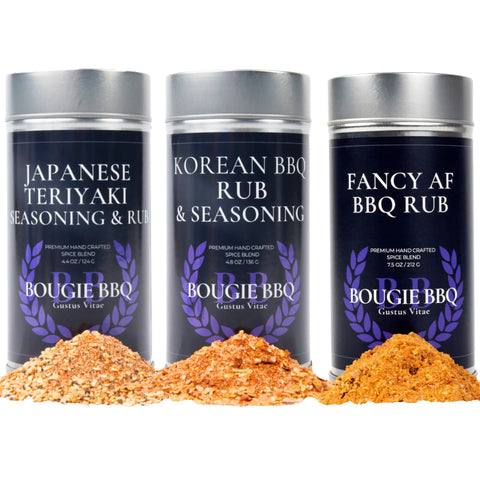 The Gustus Vitae Asian BBQ Seasonings Collection - 3 Pack features Japanese Teriyaki, Korean BBQ, and Fancy AF BBQ rubs, with piles of each gourmet blend displayed—ideal for fans of Asian-inspired barbecue flavors.