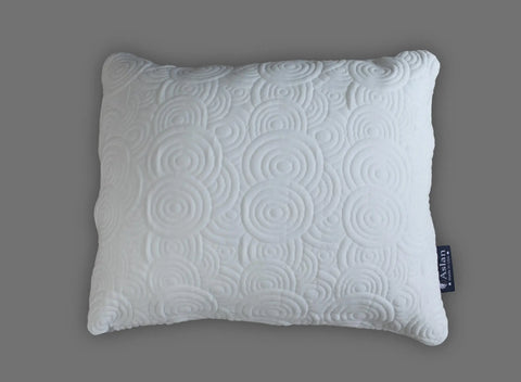 The Aslan Adjustable Pillow by Aslan Mattress is a white, rectangular pillow with an embossed circular swirl pattern and a cool-to-the-touch cover. It features a dark blue label with white text on the side and is displayed on a gray background.