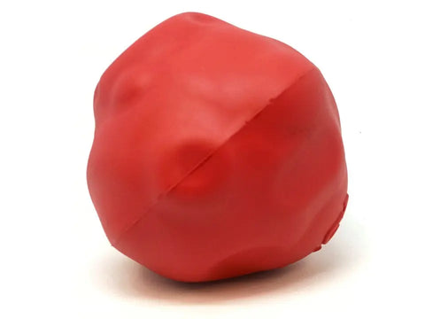 The SodaPup Asteroid Ultra Durable Rubber Chew Toy is a red, irregularly shaped natural rubber toy with a bumpy surface, shown on a white background—designed for power chewers.