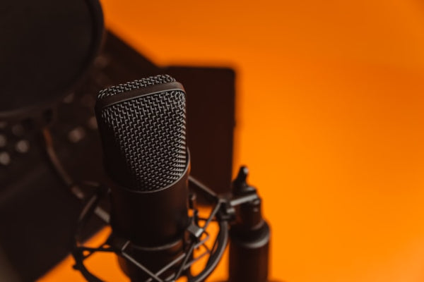 Microphone on a stand with an orange background