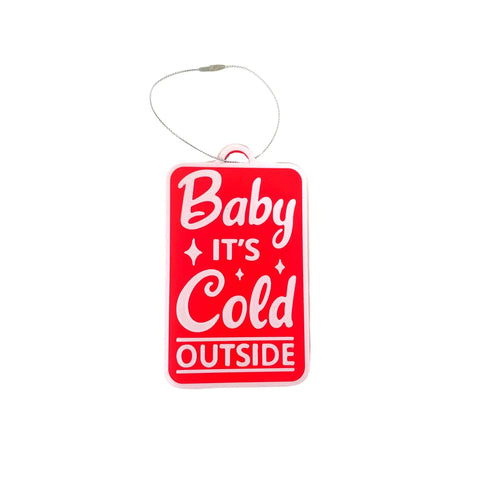 The Chatelet Manufacturing Baby Its Cold Outside Christmas Ornament is a red rectangular holiday decoration with white text, attached to a silver string—perfect for your tree. Proudly made in the USA.