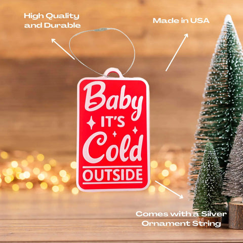 The Chatelet Manufacturing Baby Its Cold Outside Christmas Ornament is a high-quality, red holiday decoration made in the USA, hanging by a silver string—perfect for adding charm to your Christmas tree.