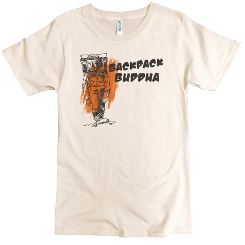The Spiritex | Sustainable Apparel Backpack Buddha Graphic Tee is a beige men’s organic cotton crewneck featuring a bold “BACKPACK BUDDHA” graphic—an illustrated figure with a large backpack in front of an orange brushstroke.
