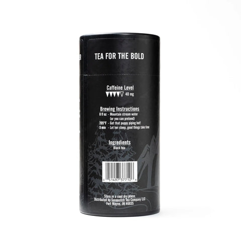 A black cylindrical tea container labeled Badlands Breakfast by Sasquatch Tea Co displays caffeine level, brewing instructions, ingredients (Irish breakfast tea), and company info in white text on the back.