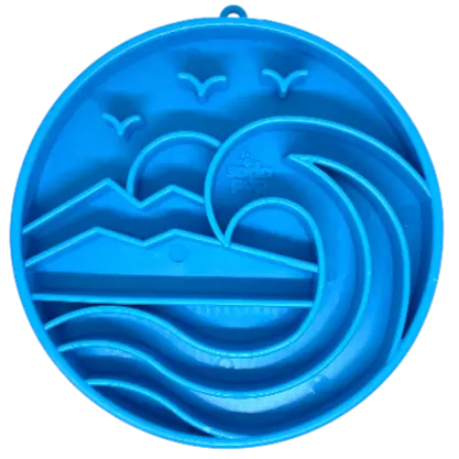 The SodaPup Baja Design ETray Enrichment Slow Feeder Tray for Dogs in light blue features raised ocean waves, mountains, and flying birds—creating a scenic landscape to engage dogs during mealtime.