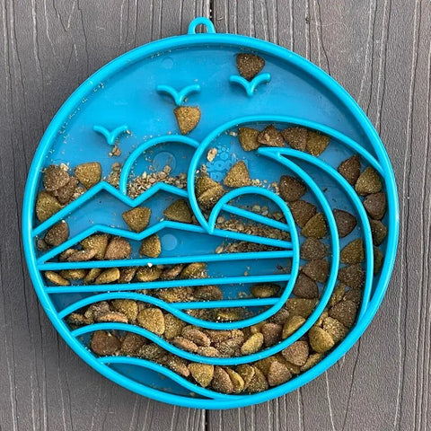 The SodaPup Baja Design ETray Enrichment Slow Feeder Tray for Dogs in light blue is a slow feeder shaped like an ocean scene, perfect for enriching your dogs mealtime with kibble or treats.