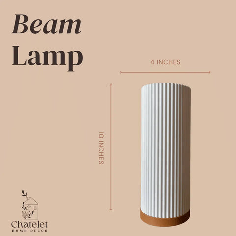 The Beam Lamp by Chatelet Manufacturing, from the Premium Collection, features a cylindrical white design with vertical ridges (10H x 4W)—ideal ambience lighting for bedrooms, living rooms, and more. Perfect for premium home decor.
