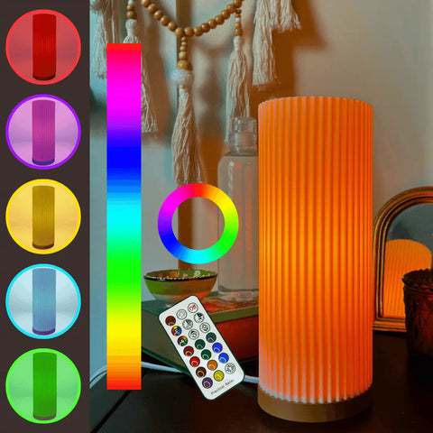 The Chatelet Manufacturing Beam Lamp, part of the Premium Collection Ambience Lighting, glows orange on a desk by a mirror and water bottle, with color options, a color wheel, and remote for bedroom or living room mood lighting.