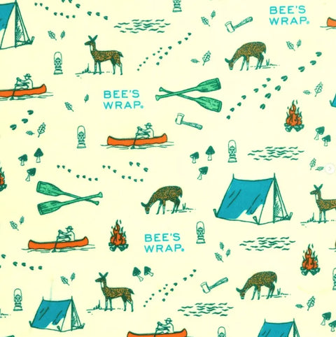 The Bee’s Wrap Roll features an illustrated outdoor camping theme with tents, deer, canoes, and campfires on a yellow background—a reusable plastic wrap replacement ideal for home bakers.