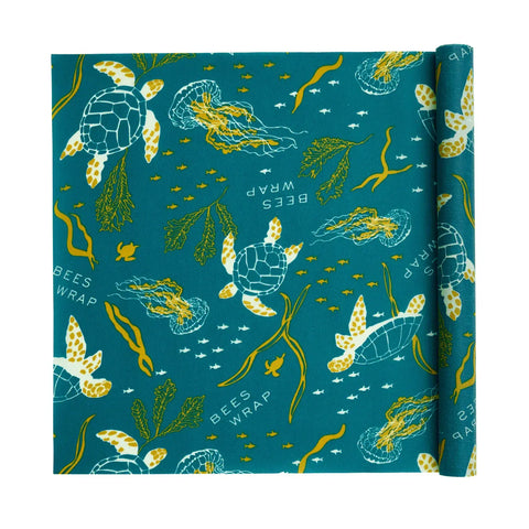 Bee’s Wrap Roll: a reusable beeswax wrap with sea turtle, jellyfish, small fish, and seaweed designs plus BEES WRAP on teal—a perfect plastic wrap alternative for bakers.