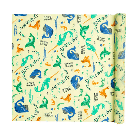 Bees Wrap Roll: a customizable, reusable beeswax wrap featuring playful whales, seals, fish, and seaweed in blue, green, and orange on light yellow. An eco-friendly plastic wrap alternative—ideal for home bakers.