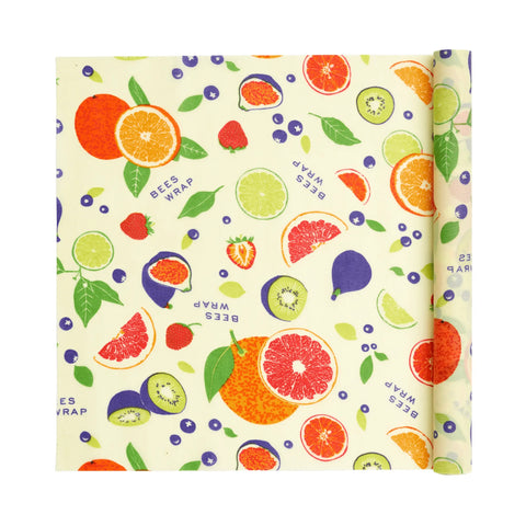 Bees Wrap Roll: a reusable beeswax food wrap with colorful fruits and leaves on pale yellow. “BEES WRAP” appears in blue text—an ideal plastic wrap alternative for eco-conscious bakers.