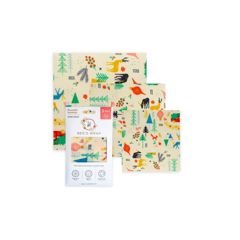 Bees Wrap Assorted 3 Pack: three beeswax food wraps in small, medium, and large sizes with colorful forest animal and tree patterns for eco-friendly food storage, shown with Bee’s Wrap packaging.
