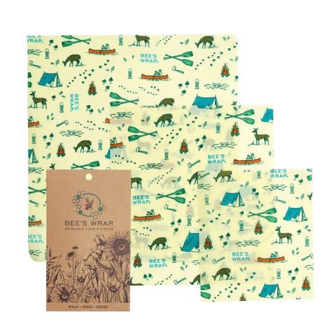 Bee’s Wrap Assorted 3 Pack includes three reusable, plastic-free wraps in a camping and wildlife print—bears, tents, canoes, and trees in green and blue. Also shown: Bee’s Wrap brown packaging with floral illustrations.