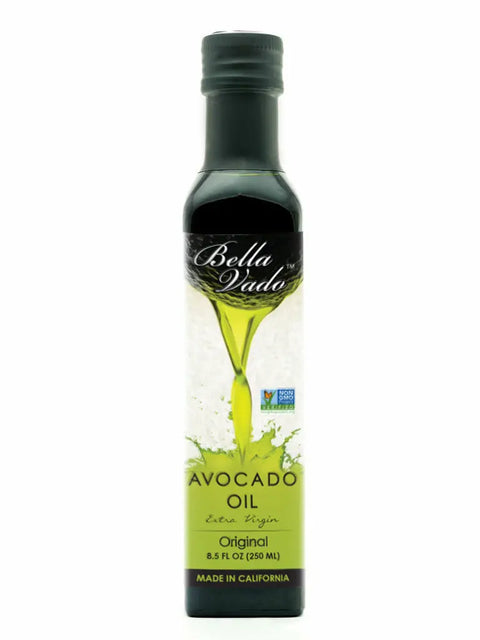A 250 ml bottle of Bella Vado Avocado Oil Extra Virgin Avocado Oil features a green label stating Original, Made in California, and the Non-GMO Project Verified logo, depicting cold-pressed avocado oil being poured.