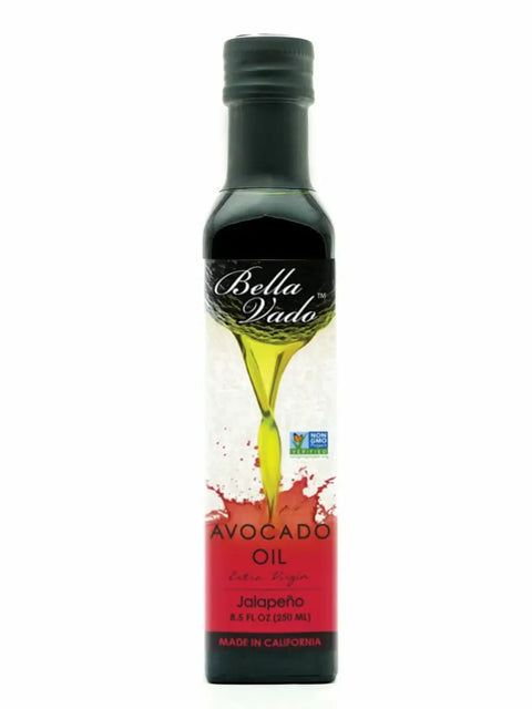 An 8.5 fl oz (250 ml) dark glass bottle of Bella Vado Avocado Oil Extra Virgin, featuring a green oil splash graphic, red label, and marked “Made in California.”.