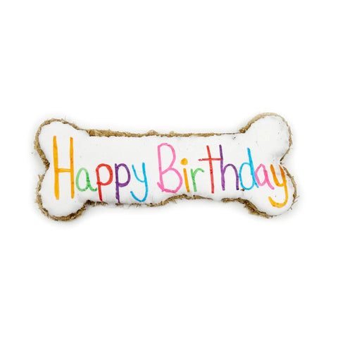 The Birthday Jumbo Bone by Brewscuits is a bone-shaped dog biscuit with white icing and Happy Birthday in colorful letters—an ideal sustainable treat for your pup’s special day.